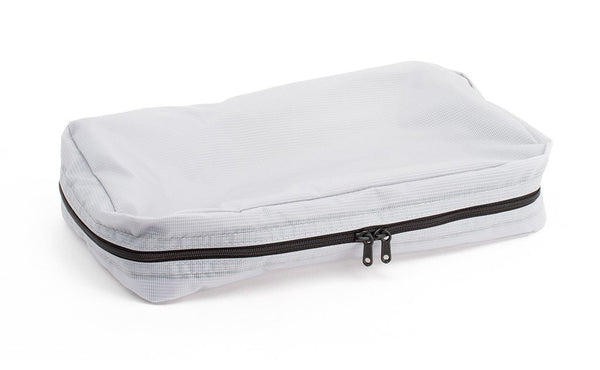 An empty and zipped closed Northwest Sky (light grey) Aether End Pocket Aeronaut 30 Packing Cube.